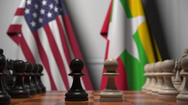 Bandeiras dos EUA e Mianmar atrás de peões no tabuleiro de xadrez. Jogo de xadrez ou rivalidade política relacionada com a renderização 3D — Fotografia de Stock