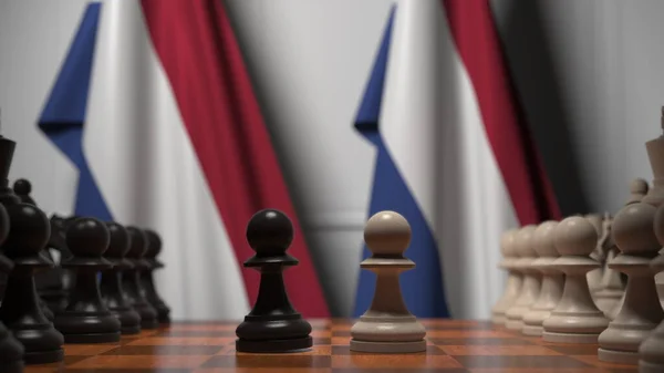 Juego de ajedrez contra banderas de Holanda. Competencia política relacionada con la representación 3D — Foto de Stock
