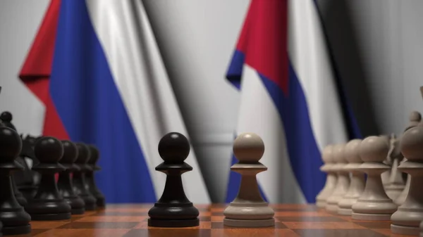 Rysslands och Kubas flaggor bakom brickor på schackbrädet. Schackspel eller politisk rivalitet relaterad till 3D-rendering — Stockfoto