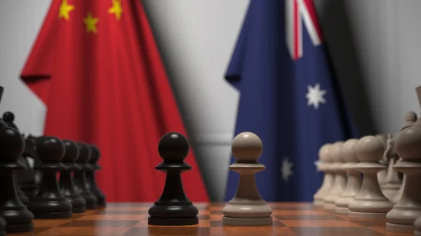 Шахматная игра против флагов Китая и Австралии. Политическая конкуренция — стоковое фото