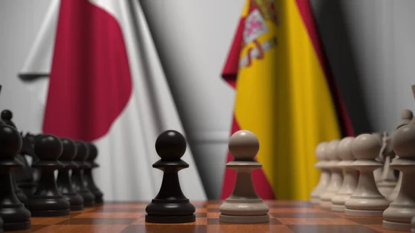 Jogo de xadrez contra bandeiras do Japão e Espanha. Renderização 3D relacionada com a concorrência política — Fotografia de Stock