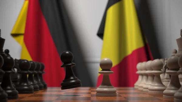 Прапори Німеччини та Бельгії за пішаками на шаховій дошці. Шахова гра або політичне суперництво пов'язують 3d рендеринг — стокове фото