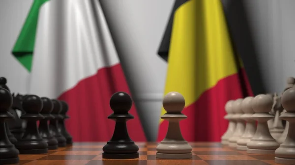 チェスボード上の質屋の後ろにイタリアとベルギーの旗。チェスゲームや政治的ライバル関係の3Dレンダリング — ストック写真