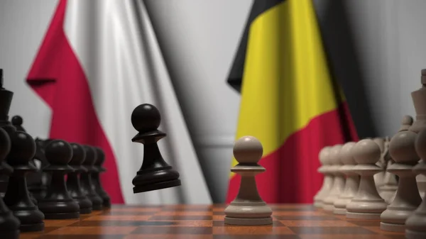 Drapeaux de la Pologne et de la Belgique derrière pions sur l'échiquier. Jeu d'échecs ou rivalité politique liée au rendu 3D — Photo