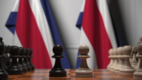 Σκάκι παιχνίδι κατά σημαίες της Κόστα Ρίκα. 3d απόδοση σχετική με τον πολιτικό ανταγωνισμό — Φωτογραφία Αρχείου