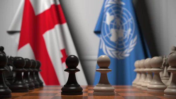 조지아 와 유엔의 깃발 이 체스 판의 졸 뒤에 있습니다. 개념적 편집 3D 렌더링 — 스톡 사진