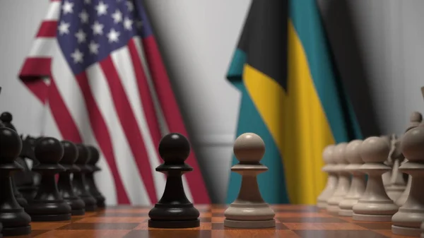Прапори Уси і Багамських островів за пішаками на шаховій дошці. Шахова гра або політичне суперництво пов'язують 3d рендеринг — стокове фото