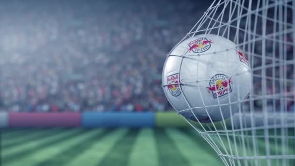 Ball with FC Red Bull Salzburg football club logo hits football goal net. Conceptual editorial 3D animation — ストック動画