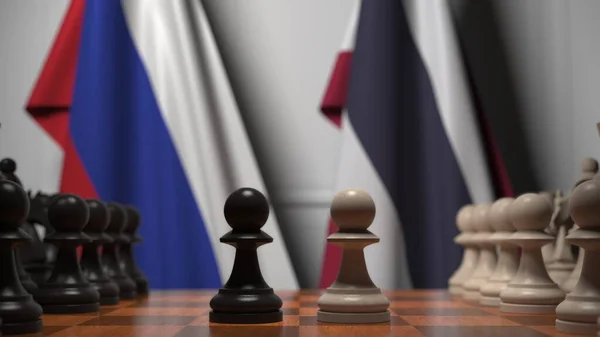 Drapeaux de la Russie et de la Thaïlande derrière pions sur l'échiquier. Jeu d'échecs ou rivalité politique liée au rendu 3D — Photo