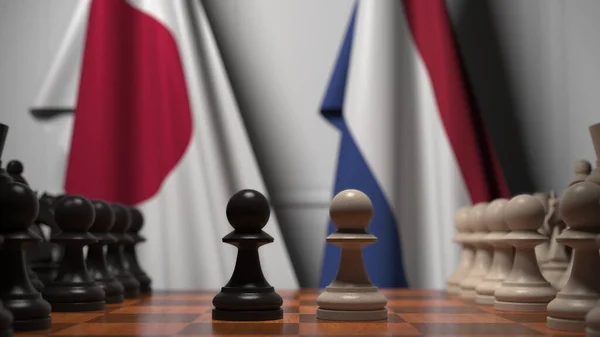 日本とオランダの国旗に対するチェスゲーム。政治競争関連の3Dレンダリング — ストック写真