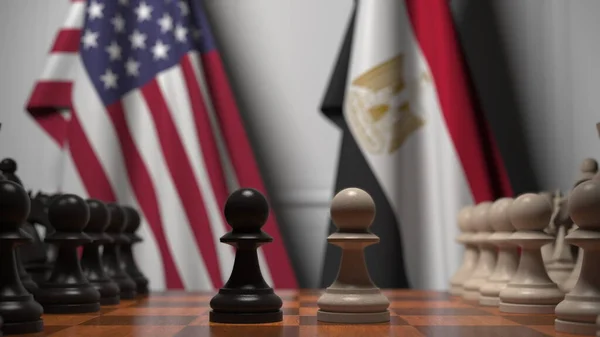 チェスボード上の質屋の後ろにアメリカとエジプトの旗。チェスゲームや政治的ライバル関係の3Dレンダリング — ストック写真