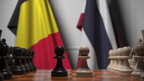 Прапори Бельгії та Таїланду за пішаками на шаховій дошці. Шахова гра або політичне суперництво пов'язують 3d рендеринг — стокове фото