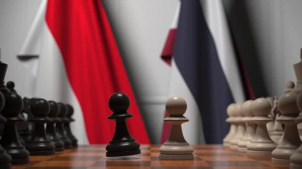 인도네시아와 태국의 국기가 체스 판의 기둥 뒤에 걸려 있습니다. 체스 게임이나 정치적 라이벌은 3D 렌더링 과 관련 이 있다. — 스톡 사진