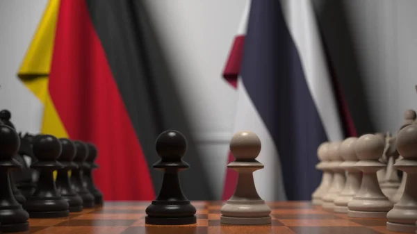 Zászlók Németország és Thaiföld mögött gyalogok a sakktáblán. Sakk játék vagy politikai rivalizálás kapcsolódó 3d renderelés — Stock Fotó