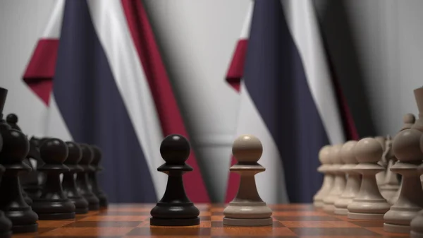 Bandeiras da Tailândia atrás de peões no tabuleiro de xadrez. Jogo de xadrez ou rivalidade política relacionada com a renderização 3D — Fotografia de Stock