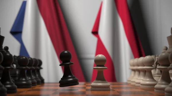 Drapeaux des Pays-Bas et de l'Autriche derrière des pions sur l'échiquier. Jeu d'échecs ou rivalité politique liée au rendu 3D — Photo