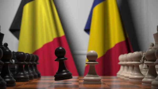 Flaggen von Belgien und Rumänien hinter Bauern auf dem Schachbrett. Schachspiel oder politische Rivalität im Zusammenhang mit 3D-Darstellung — Stockfoto