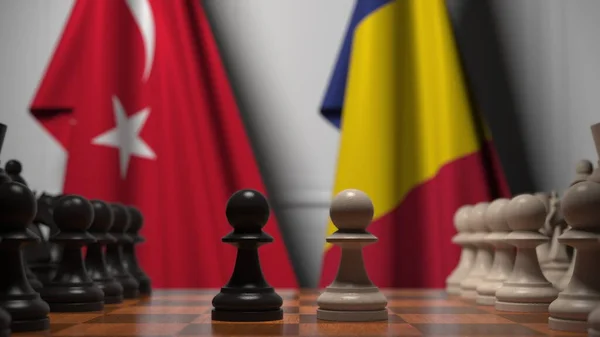 Türkiye ve Romanya bayrakları satranç tahtasındaki piyonların arkasında. Satranç ya da siyasi çekişme ile ilgili 3 boyutlu yorumlama — Stok fotoğraf