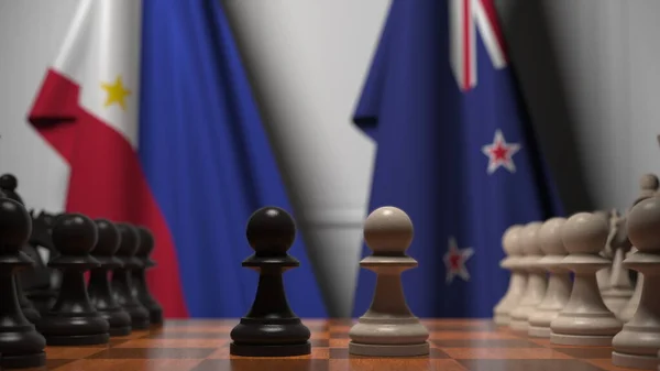 필리핀 과 뉴질랜드의 국기가 체스 판의 졸 뒤에 있습니다. 체스 게임이나 정치적 라이벌은 3D 렌더링 과 관련 이 있다. — 스톡 사진