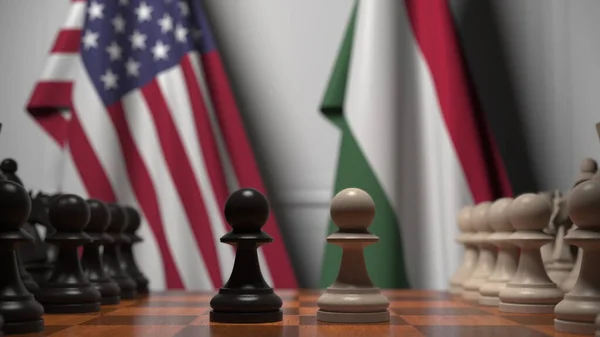 Флаги США и Венгрии за пешками на шахматной доске. Шахматная игра или политическое соперничество — стоковое фото
