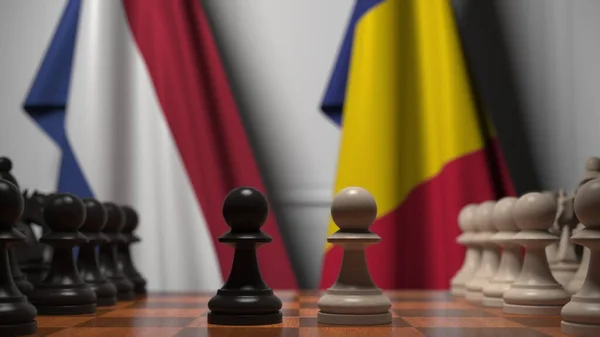 Hollandia és Románia zászlói gyalogok mögött a sakktáblán. Sakk játék vagy politikai rivalizálás kapcsolódó 3d renderelés — Stock Fotó