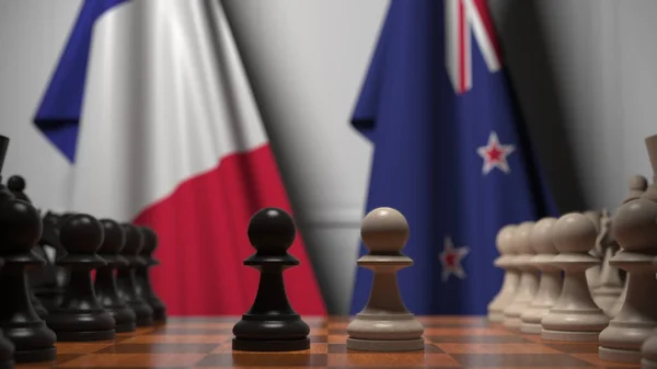 Bandeiras da França e Nova Zelândia atrás de peões no tabuleiro de xadrez. Jogo de xadrez ou rivalidade política relacionada com a renderização 3D — Fotografia de Stock