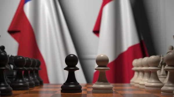 Флаги Чили и Перу за пешками на шахматной доске. Шахматная игра или политическое соперничество — стоковое фото