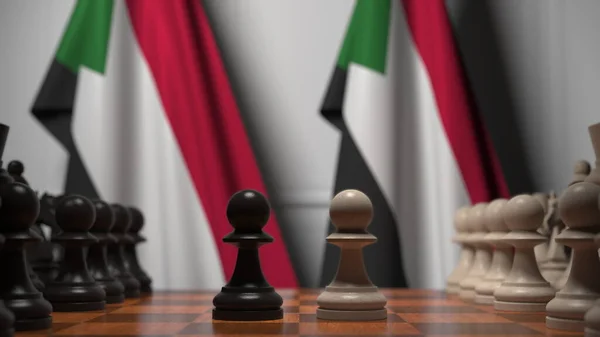 Шахматная игра против флагов Судана. Политическая конкуренция — стоковое фото