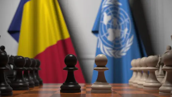 Прапори Румунії та пішаків United Nationsbehind на шахівниці. Політичне суперництво пов'язане з 3d рендерингом — стокове фото
