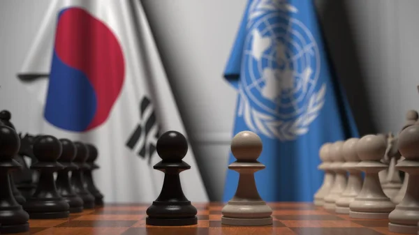 チェス盤の駒の後ろに韓国と国連の旗。概念編集3Dレンダリング — ストック写真