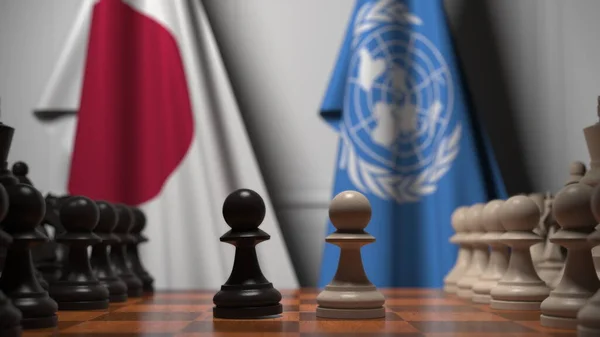 체스 판의 졸 뒤에 있는 일본 과 국제 연합의 깃발. 개념적 편집 3D 렌더링 — 스톡 사진