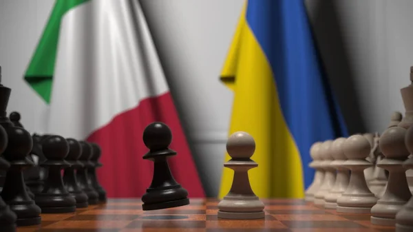 Drapeaux de l'Italie et de l'Ukraine derrière pions sur l'échiquier. Jeu d'échecs ou rivalité politique liée au rendu 3D — Photo