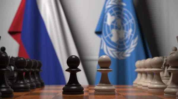 Oroszország és az ENSZ zászlói a gyalogok mögött a sakktáblán. Sakk játék vagy politikai rivalizálás kapcsolódó 3d renderelés — Stock Fotó