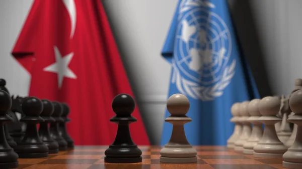 Türkiye ve Birleşmiş Milletler bayrakları satranç tahtasındaki piyonların arkasında. Satranç ya da siyasi çekişme ile ilgili 3 boyutlu yorumlama — Stok fotoğraf