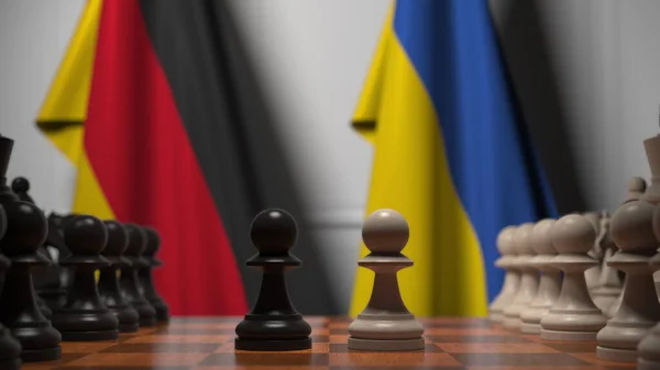 Flaggen von Deutschland und der Ukraine hinter Bauern auf dem Schachbrett. Schachspiel oder politische Rivalität im Zusammenhang mit 3D-Darstellung — Stockfoto