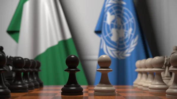 나이지리아와 유엔의 깃발 이 체스 판의 졸 뒤에 있습니다. 개념적 편집 3D 렌더링 — 스톡 사진