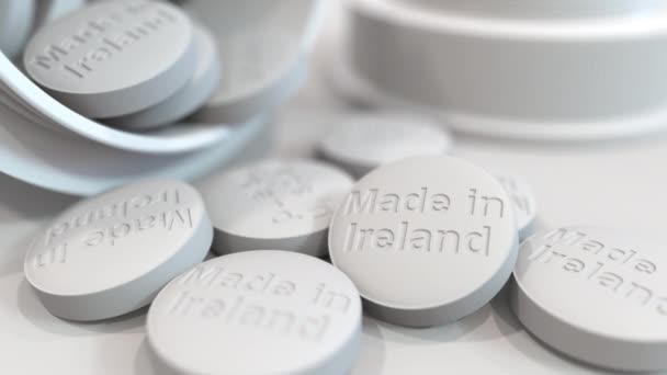 Pills with MADE IN IRELAND text on them. National pharmaceutical industry related 3D animation — ストック動画