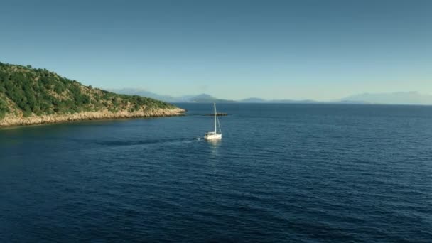 Aerial view of unknown sailing yacht running motor at sea, Greece — Stock Video