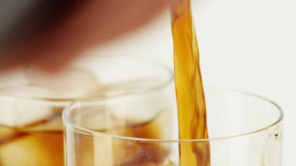 Pouring sparkling cola soft drink into a glass, close-up slow motion shot on Red — Stock Video