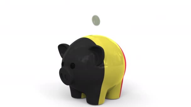 Coins fall into piggy bank painted with flag of Belgium. National banking system or savings related conceptual 3D animation — Stock Video