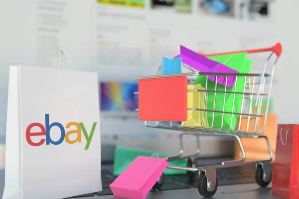 Bolsa com logotipo do eBay e carrinho de compras em um teclado de laptop. Editorial compras on-line relacionados 3D renderização — Fotografia de Stock