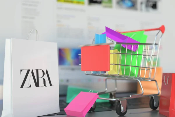 Taška s logem Zara a nákupním vozíkem na klávesnici notebooku. Editorial online nakupování související 3D vykreslování — Stock fotografie