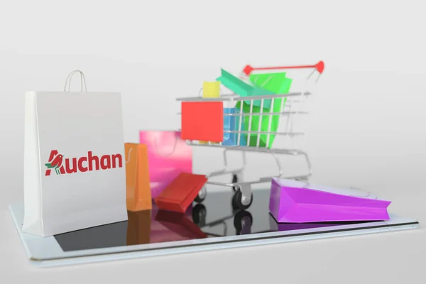 Nákupní košík na tabletu a papírový sáček s logem Auchan. Editorial e-commerce related 3D rendering — Stock fotografie