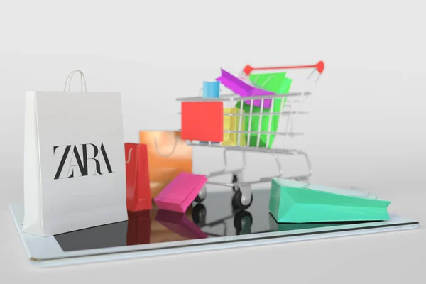 Shopping cart on a tablet computer and paper bag with Zara logo. Editorial e-commerce related 3D rendering — Stock Photo, Image