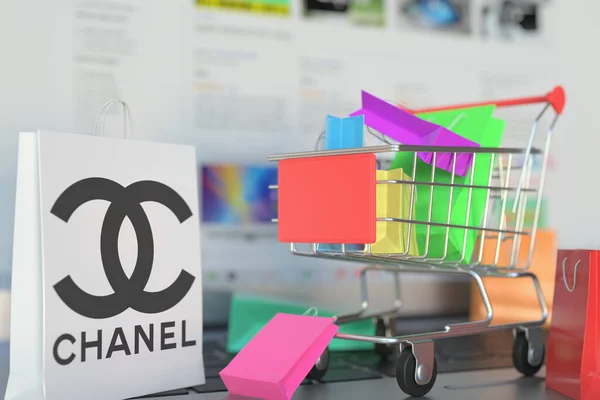 바그는 샤넬 로고와 쇼핑 카트를 노트북 키보드에 부착 했다. 편집 된 온라인 쇼핑 관련 3D 렌더링 — 스톡 사진
