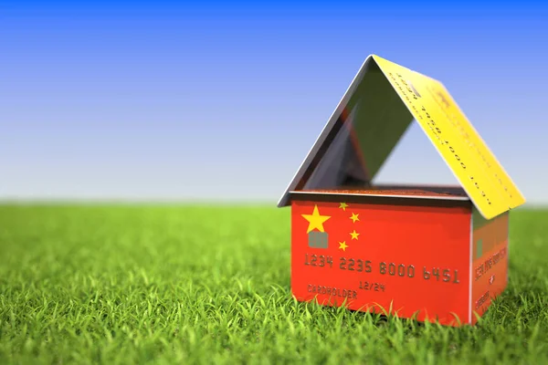 Flag of China on plastic bank card house in the grass. Mortgage related 3D rendering — Stock Photo, Image