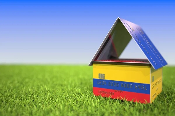 草の中のプラスチック製の銀行カードの家にコロンビアの旗。住宅ローン関連3Dレンダリング — ストック写真