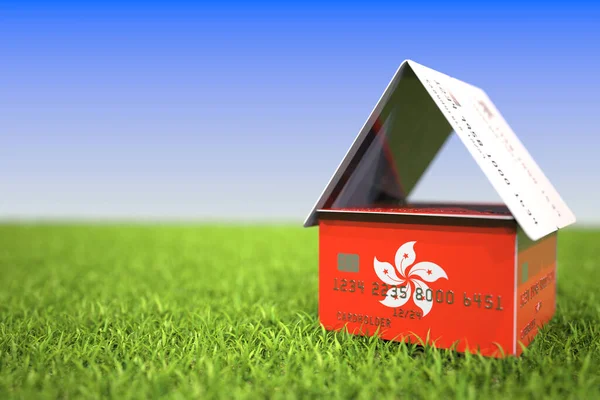 National flag of Hong Kong on credit card house in the grass. Home loans related 3D rendering — Stock Photo, Image