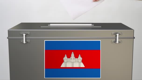Hand zetten papier stembiljet in stembus met vlag van Cambodja. Verkiezingsgerelateerde clip — Stockvideo