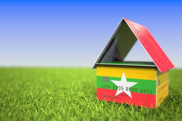 Flagga Myanmar på plast bankkort hus i gräset. Hypoteksrelaterad 3D-återgivning — Stockfoto